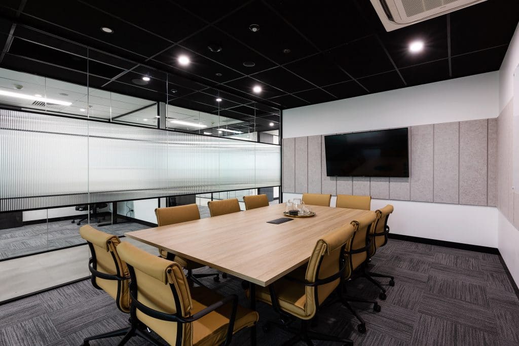 a boardroom for ten people with tv and white board