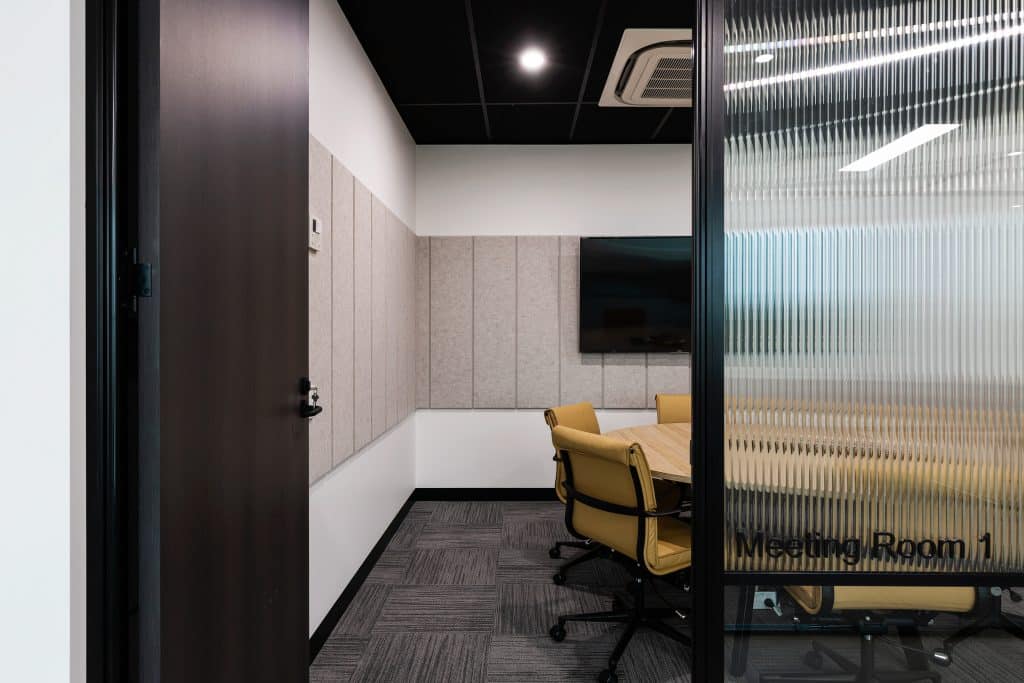 a meeting room with round table and tv