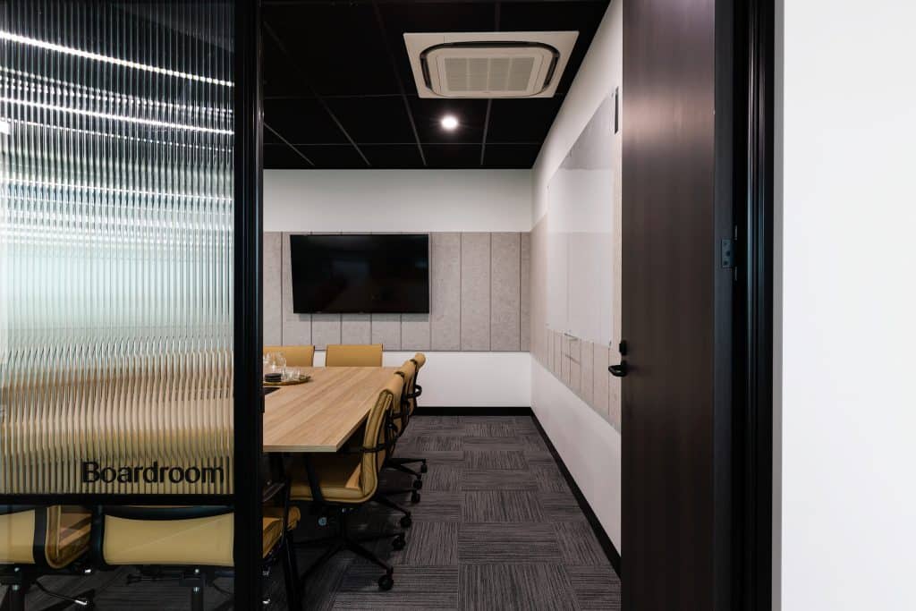 a boardroom for ten people with tv and white board