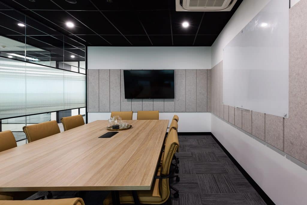 a boardroom for ten people with tv and white board
