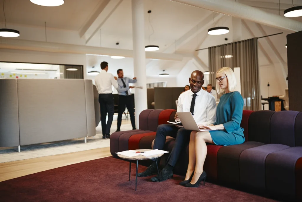 Office workers in a lounge enjoying the benefits of serviced offices
