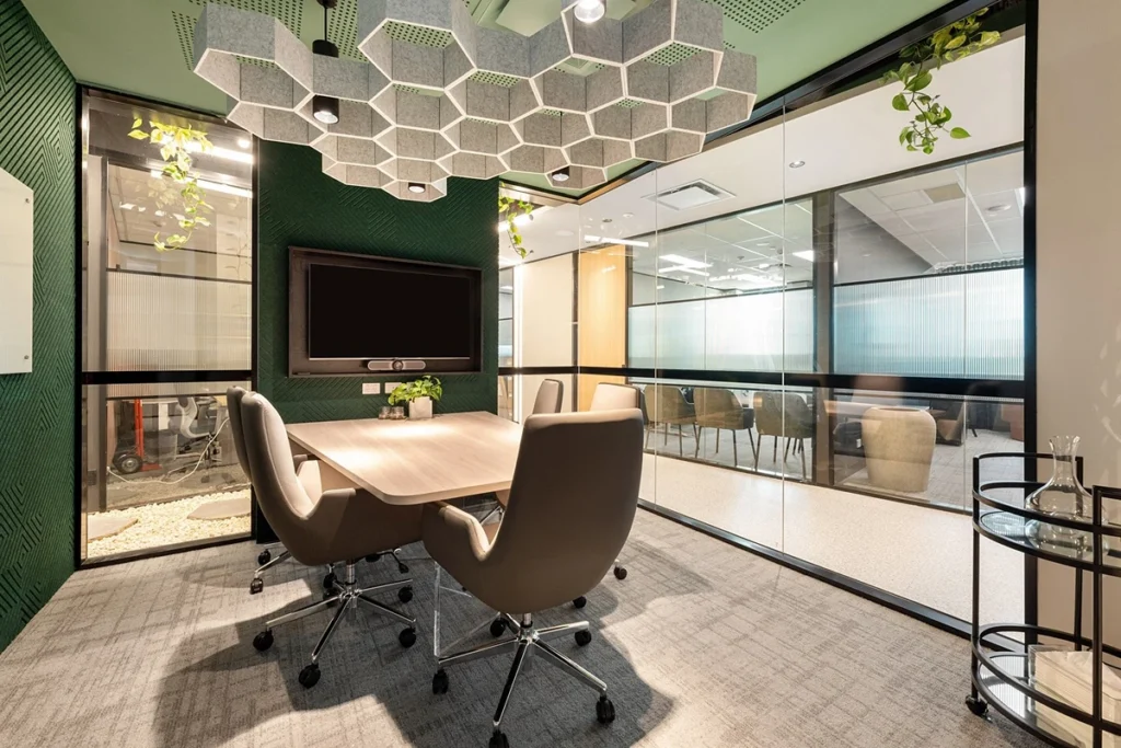 A meeting room, one of the amenities often available with flexible office space. Plants decorate the table and windows.